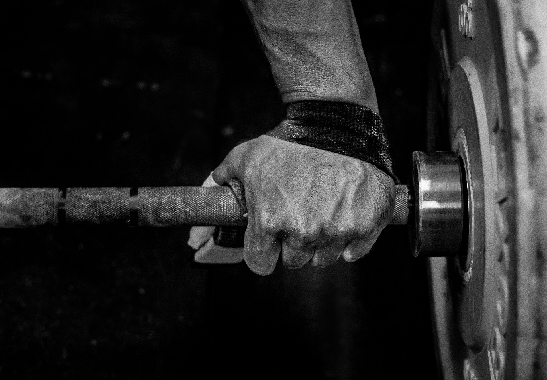 Close-Up Of Male Hands Holding Weights